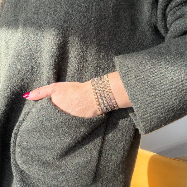 LeJu Glimmer bracelet stack styled with a grey cardigan