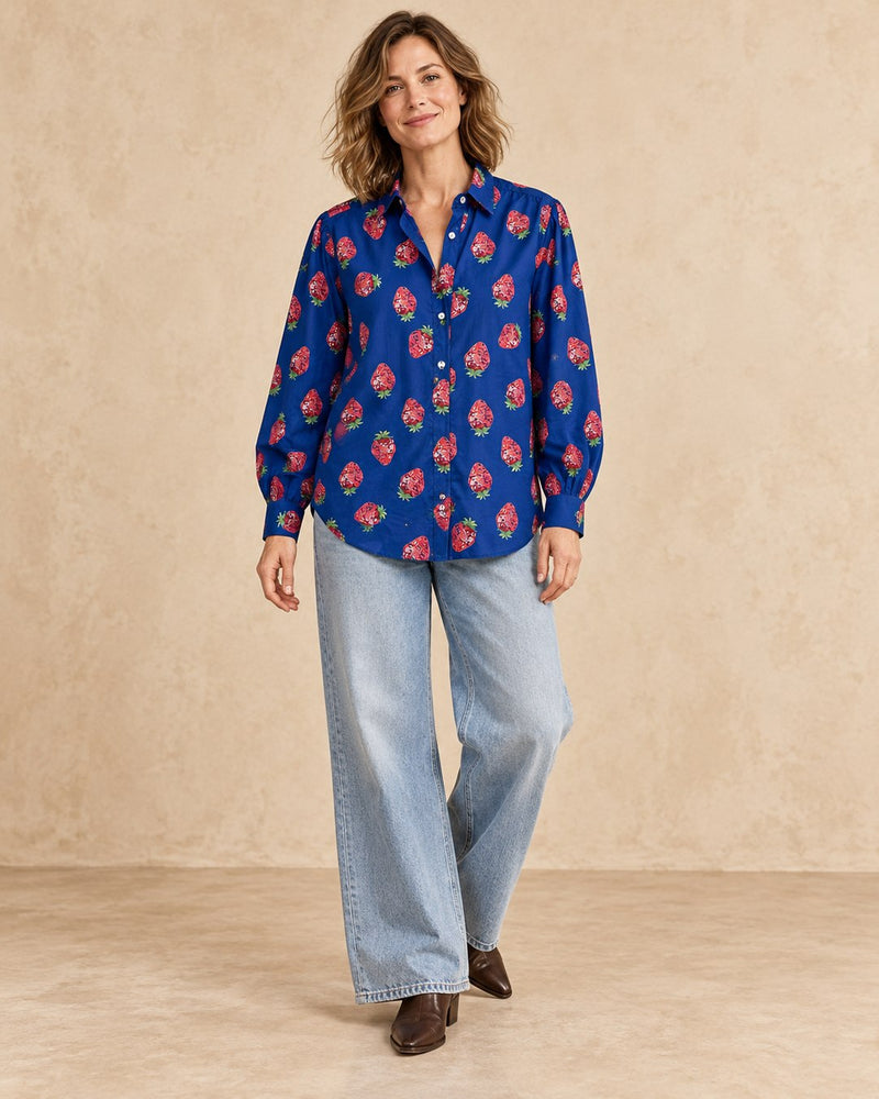 Model wearing Strawberry Disco Shirt untucked with wide light-wash jeans and leather boots
