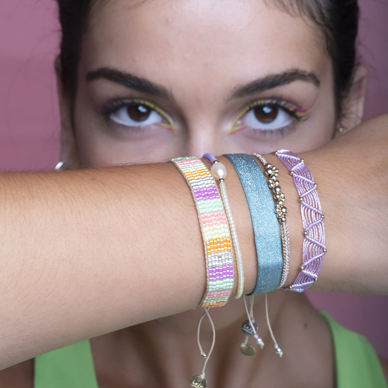 This stunning adjustable bracelet is handwoven by our team of master artisans using Japanese  glass beads in neon tones.  Wear yours stacked or solo to add a mood-boosting pop of color to any neutral look!  Details:      Japanese glass beads     Handwoven adjustable bracelet     Width11mm     Can be worn in the water