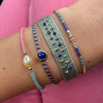   - Handwoven using Polyester  -Semi-precious stones  -14  gold filled beads  - Can be worn in the water - Width 8 mm -Adjustable bracelet -Women bracelet