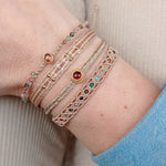 HANDWOVEN ROMA BRACELET IN GOLD TONES FEATURING GEMSTONES DETAIL