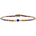   Handwoven in Colombia, this feminine bracelet features a single row of Japanese glass beads in gold and bright tones with a Lapis Lazuli stone of strenght and discipline in the centre.  Wear this stylish bracelet alone or as a part of a bracelet layering combination, with your favourite jeans & t-shirt!  Details:  - Japanese glass beads  - Silver faceted beads  -Lapis lazuli  - Width: 2mm  - Adjustable bracelet 