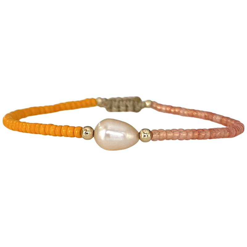 Make a confident statement with this beautiful handmade bracelet. This design is handwoven by our team of artisans using japanese glass beads,14k gold filled beads and a freshwater pearl.  This bracelet is elegant and femenine, making it the perfect accessory for any occasion.  Details  - Japanese glass beads   - 14 k gold filled beads  - Adjustable Bracelet  -Width: 2mm  -Can be worn in the  water