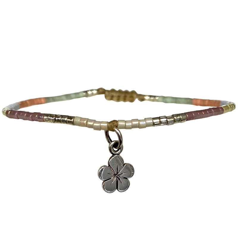 This beautiful kids bracelet is handwoven using Japanese glass beads and a 925 sterling silver flower charm.    Wear it with your favourite accessories!  Details:  -Kids bracelet  - Japanese glass beads  - 925 sterling silver charm   -Width: 2mm  -Adjustable bracelet