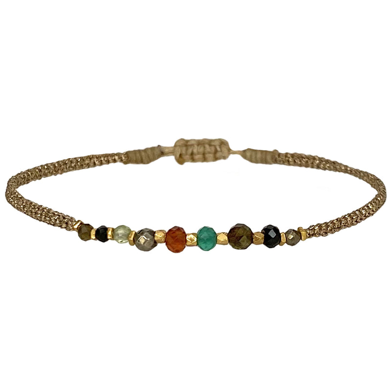 Delicate & feminine, our gypsy bracelet is handwoven using metallic gold threads and intermixed semi-precious stones.   Wear it with your favourite accessories all season long!  Details:  - Intermixed semi-precious stones   - vermeil faceted beads   -Metallic threads  -Adjustable bracelet   -Can be worn in the water  -It comes with a card and a gift box 