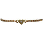 This delicate bracelet is handmade by our team of master artisans using metallic threads and a gold heart charm encrusted with a sparkling quartz stone. It's the perfect accessory to add a little sparkle in your life.  Details:      Quartz semi-precious stone     Gold Vermeil setting     Macramé weaving technique     Adjustable handwoven bracelet     Width 4mm