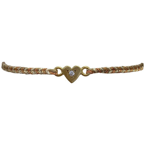 This delicate bracelet is handmade by our team of master artisans using metallic threads and a gold heart charm encrusted with a sparkling quartz stone. It's the perfect accessory to add a little sparkle in your life.  Details:      Quartz semi-precious stone     Gold Vermeil setting     Macramé weaving technique     Adjustable handwoven bracelet     Width 4mm