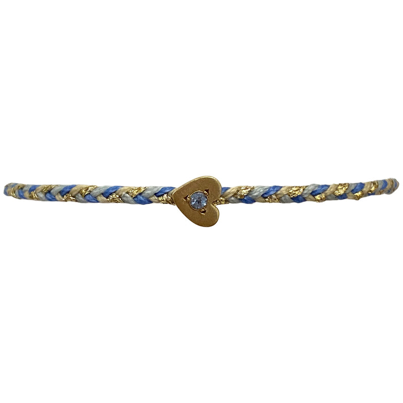 This delicate bracelet is handmade by our team of master artisans using metallic threads and a gold heart charm encrusted with a sparkling quartz stone. It's the perfect accessory to add a little sparkle in your life.  Details:      Quartz semi-precious stone     Gold Vermeil setting     Women bracelet     Adjustable handwoven bracelet     Width 5mm