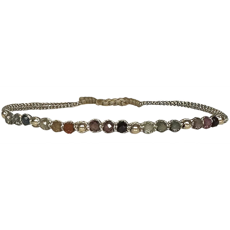 If you wish for sophistication and originality this bracelet is just for you. It is handwoven by our team of artisans using tundra sapphire semi-precious stones, 14 k gold filled beads and metallic threads.  The tundra sapphire stone will bring you balance within the body, lightness and joy.  Details:  - Tundra sapphire semi-precious stones  - 14k gold filled beads  - Metallic threads  -Adjustable bracelet  -Width: 4mm