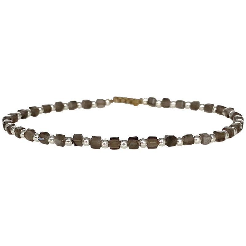 This delicate jewel is handmade using 925 silver beads and Gold Obsidian semi-precious stones. This beauty will be one of your favorite bracelets as you can wear it with any accessories or outfits. Give to your looks a touch of elegance and sparkle !  Details:  - Gold Obsidian semi-precious stones   - 924 Sterling silver beads  -Adjustable bracelet  -width: 2m  -Can be worn in the water