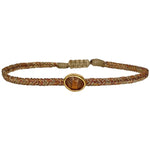 Wear it with your favourite accessories all season long, and with its adjustable pull cord you will always have the perfect fit!  Details:  - Hessonite precious stone  - Vermeil setting   -Metallic threads  -Adjustable bracelet   -Take care of your jewellery by keeping it dry and avoid spraying fragrances directly on to it.   -It comes with a card and a gift box 