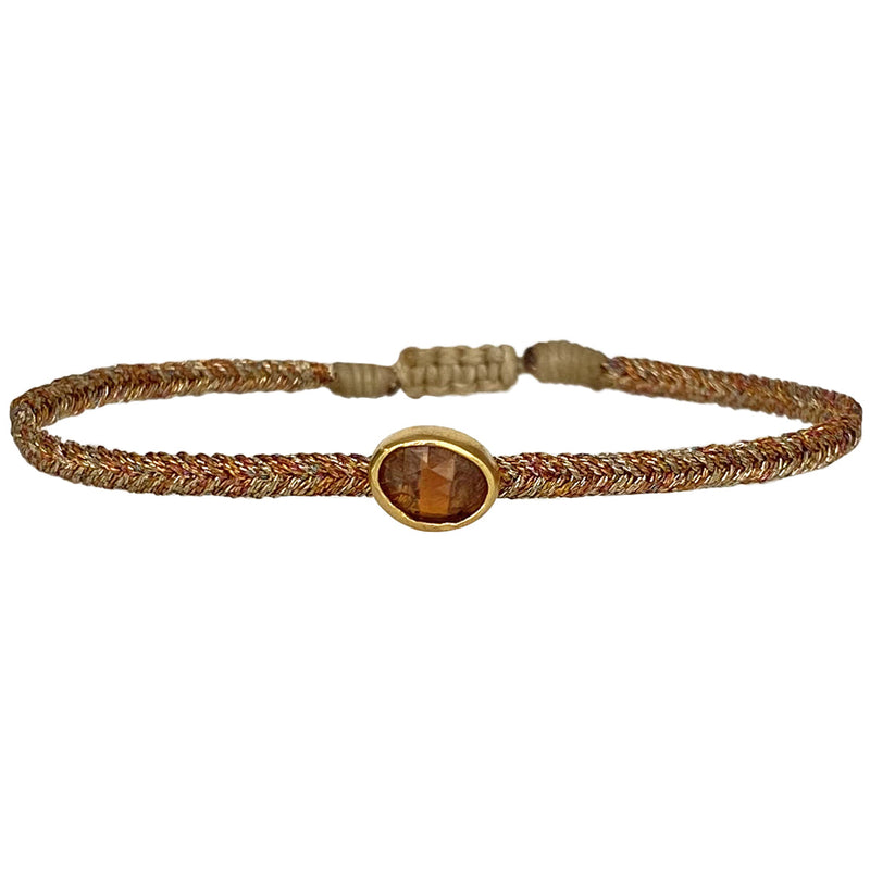 Wear it with your favourite accessories all season long, and with its adjustable pull cord you will always have the perfect fit!  Details:  - Hessonite precious stone  - Vermeil setting   -Metallic threads  -Adjustable bracelet   -Take care of your jewellery by keeping it dry and avoid spraying fragrances directly on to it.   -It comes with a card and a gift box 