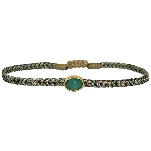 Delicate & feminine, this bracelet is handwoven using metallic gold and green threads and features a green onyx precious stone centrepiece. Onyx stones are symbols of happiness.  Wear it with your favourite accessories all season long, and with its adjustable pull cord you will always have the perfect fit!  Details:  - Onyx precious stone  - Vermeil setting   -Metallic threads  -Adjustable bracelet 