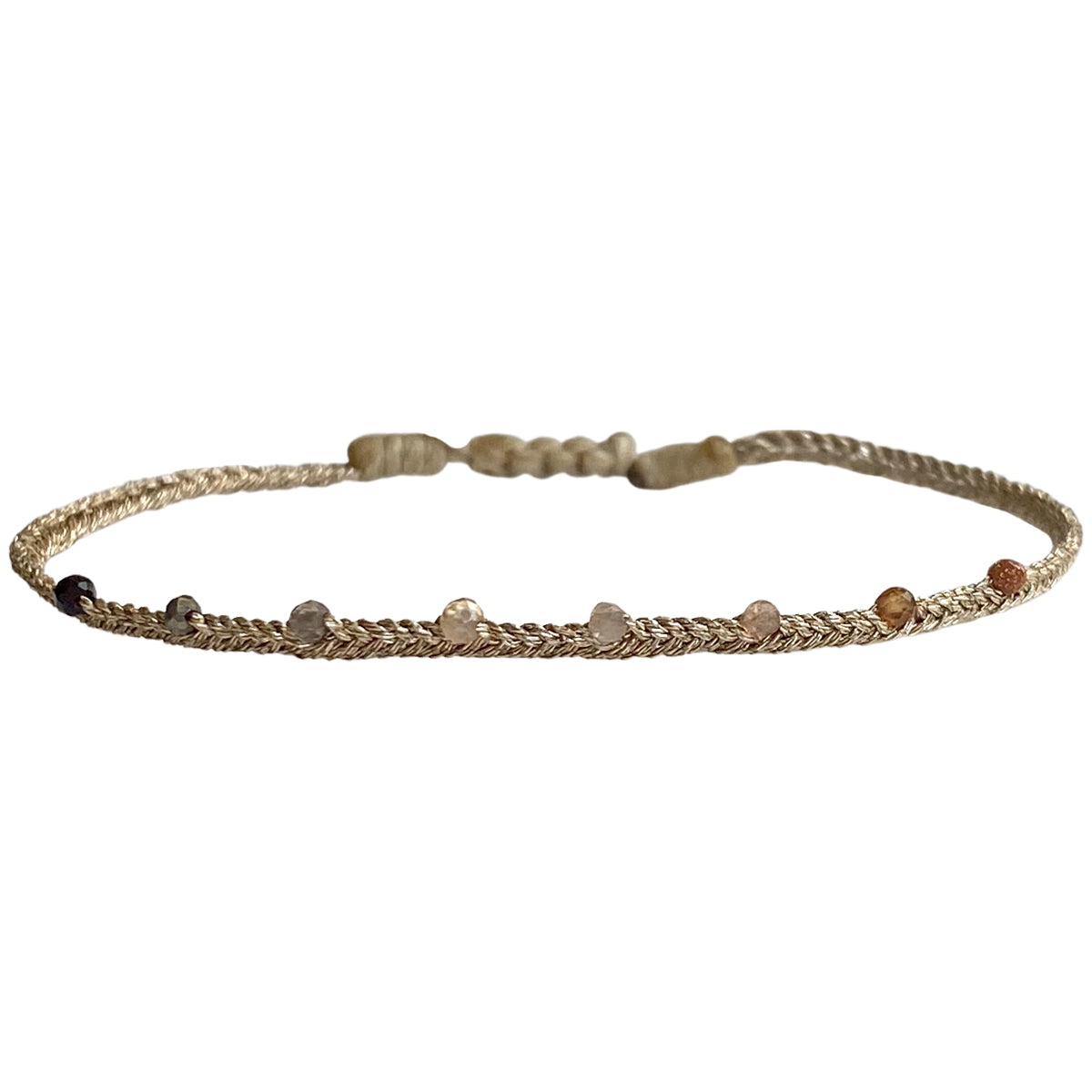 This LeJu bracelet has been handwoven in Colombia by our team of artisans using  metallic threads and intermixed semi-precious stones.  Wear it with your favourite accessories .  Details:  -Intermixed semi-precious stones  - Handwoven using metallic threads  - Width 3mm  - Adjustable bracelet  -Can be worn in the water