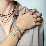 This delicate and beautiful bracelet is handwoven by our team of artisans using 14K gold filled beads and metallic threads.   You can wear it with your favourite bracelets all season long.   Details:  -14k gold filled beads details   -Adjustable bracelet  -Width: 4mm  -Can be worn in the  water