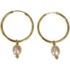 This gorgeus hoop earrings are so simple and femenine. Handmade by our team of master artisans using a vermeil hoop decorated with a delicated freshwater pearl.     Details:  - Handmade earrings  - 24k Gold vermeil Hoop on 925 sterling silver   -Hoop diameter: 25mm, lenght: 48 mm  -Freshwater pearls  -Vermeil Beads