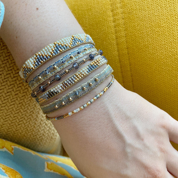 HANDMADE SET OF THREE BRACELETS IN BLUE & GOLD TONES ON MODEL