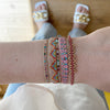 BRIGHT PINK SET OF TWO HANDMADE BEADED BRACELETS WITH PINK TOURMALINE STONE ON MODEL