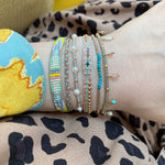SET OF THREE HANDMADE BRACELETS IN BLUE, LILAC & ROSE GOLD TONES ON MODEL