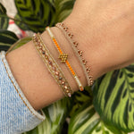 HANDWOVEN HEART BRACELET IN ORANGE AND GOLD