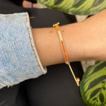 HANDWOVEN HEART BRACELET IN ORANGE AND GOLD