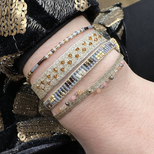 Handwoven in Colombia, this feminine bracelet features a single row of Japanese glass beads in silver and pink tones.  Wear this stylish bracelet alone or as a part of a bracelet layering combination, with your favourite jeans & t-shirt!  Details:  - Japanese glass beads  - Width: 2mm  - Adjustable bracelet 