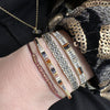 beads in brown tones with a peach sunstone in the centre  Wear this stylish bracelet alone or as a part of a bracelet layering combination, with your favourite jeans & t-shirt!  Details:  - Japanese glass beads  - Peach sunstone  - Width: 2mm  - Adjustable bracelet   -Can be worn in the water