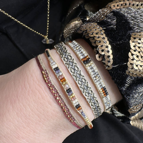 beads in brown tones with a peach sunstone in the centre  Wear this stylish bracelet alone or as a part of a bracelet layering combination, with your favourite jeans & t-shirt!  Details:  - Japanese glass beads  - Peach sunstone  - Width: 2mm  - Adjustable bracelet   -Can be worn in the water
