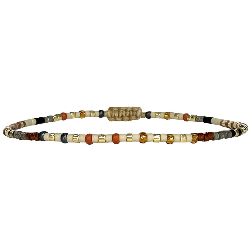 Handwoven in Colombia, this feminine bracelet features a single row of Japanese glass beads in silver and pink tones.  Wear this stylish bracelet alone or as a part of a bracelet layering combination, with your favourite jeans & t-shirt!  Details:  - Japanese glass beads  - Width: 2mm  - Adjustable bracelet 