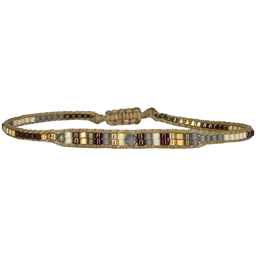 Handwoven in Colombia, this feminine bracelet features a single row of Japanese glass beads in blue and silver tones with a Iolite stone in the centre  Wear this stylish bracelet alone or as a part of a bracelet layering combination, with your favourite jeans & t-shirt!  Details:  - Japanese glass beads  - Iolite stone  - Width: 2mm  - Adjustable bracelet   -Can be worn in the water
