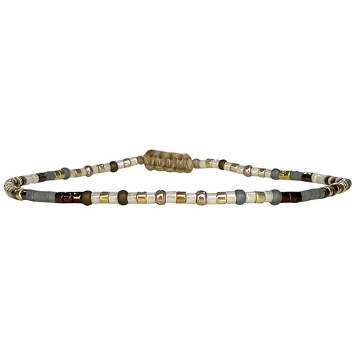 Handwoven in Colombia, this feminine bracelet features a single row of Japanese glass beads in silver and pink tones.  Wear this stylish bracelet alone or as a part of a bracelet layering combination, with your favourite jeans & t-shirt!  Details:  - Japanese glass beads  - Width: 2mm  - Adjustable bracelet 