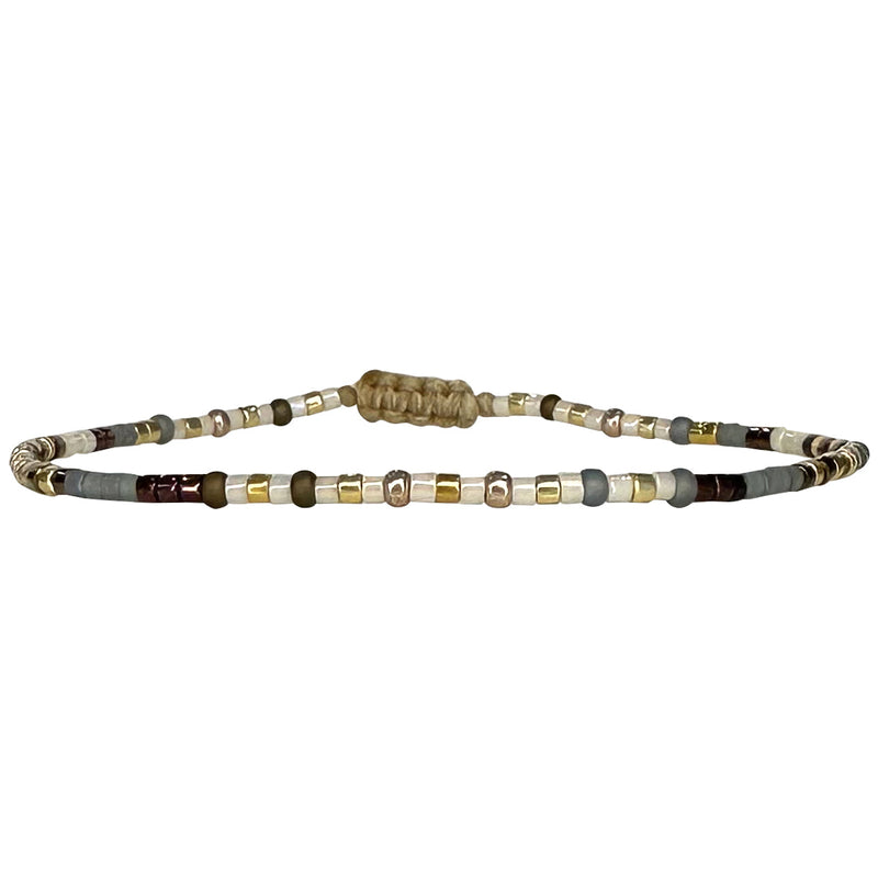 Handwoven in Colombia, this feminine bracelet features a single row of Japanese glass beads in silver and pink tones.  Wear this stylish bracelet alone or as a part of a bracelet layering combination, with your favourite jeans & t-shirt!  Details:  - Japanese glass beads  - Width: 2mm  - Adjustable bracelet 