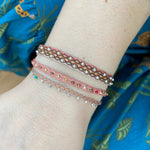 COLOURFUL HANDWOVEN BRACELET IN PINK TONES AND SILVER DETAILS