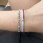 HANDWOVEN BRACELET IN BRIGHT TONES WITHONE GOLD BEAD