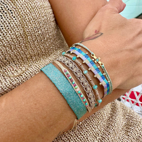   This beautiful hadmade bracelet has been handwoven in Colombia by our team of artisans using Polyester threads in blue tones with 14k gold filled beads.  This can be worn solo or with your favourite pieces.  Details:      Polyester threads     14k gold filled beads     Handwoven adjustable bracelet     Width 5mm     Can be worn in the water     Women bracelet