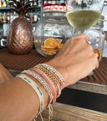CURVE HANDMADE BRACELET IN NEON TONES WITH GOLD CHAIN DETAIL