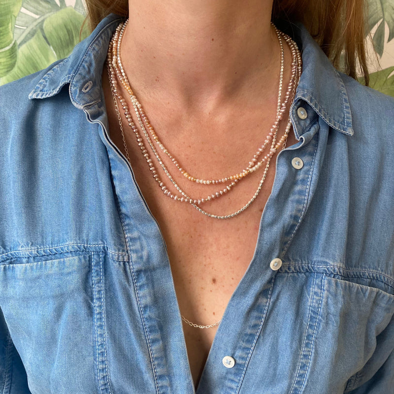 HANDMADE NEACKLACE FEATURING BEAUTIFUL PEACH, LILAC AND WHITE PEARLS ON MODEL