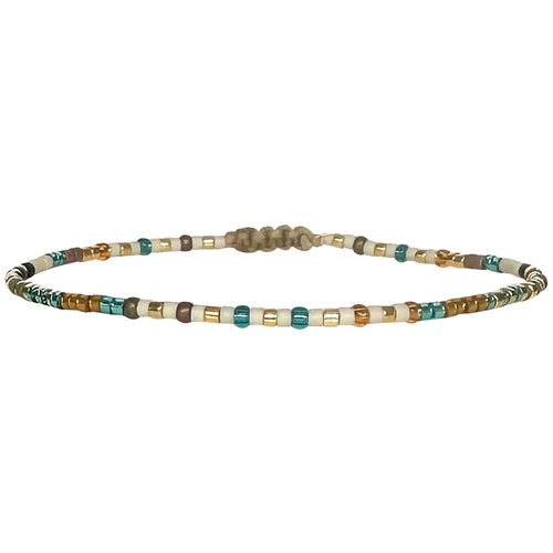 Handwoven in Colombia, this feminine bracelet features a single row of Japanese glass beads.  Wear this stylish bracelet alone or as a part of a bracelet layering combination, with your favourite jeans & t-shirt!  Details:  - Japanese glass beads  - Width: 2mm  - Adjustable bracelet 