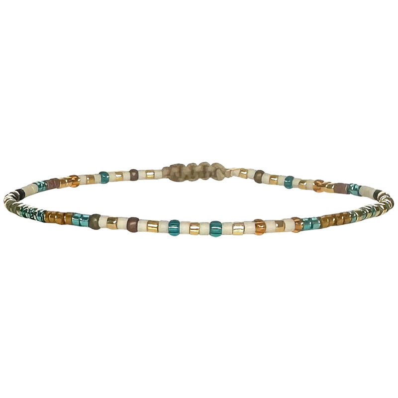 Handwoven in Colombia, this feminine bracelet features a single row of Japanese glass beads.  Wear this stylish bracelet alone or as a part of a bracelet layering combination, with your favourite jeans & t-shirt!  Details:  - Japanese glass beads  - Width: 2mm  - Adjustable bracelet 