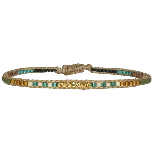 Handwoven in Colombia, this feminine bracelet features a single row of Japanese glass beads and gold faceted beads  Wear this stylish bracelet alone or as a part of a bracelet layering combination, with your favourite jeans & t-shirt!  Details:  -Gold faceted beads  - Japanese glass beads  - Width: 2mm  - Adjustable bracelet 