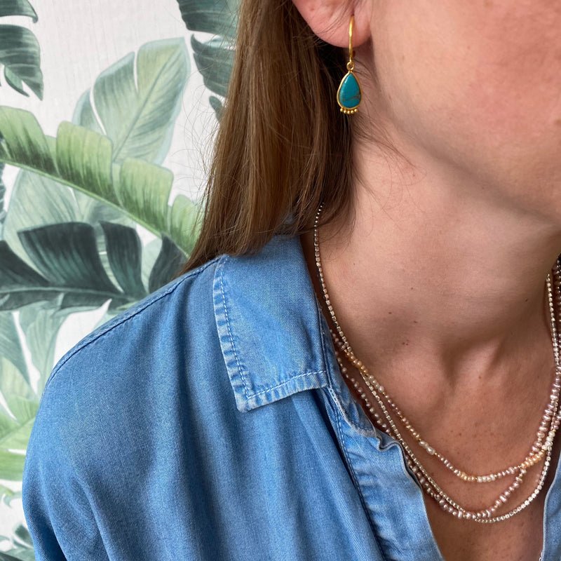 HANDMADE TURQUOISE DROP EARRINGS ON MODEL