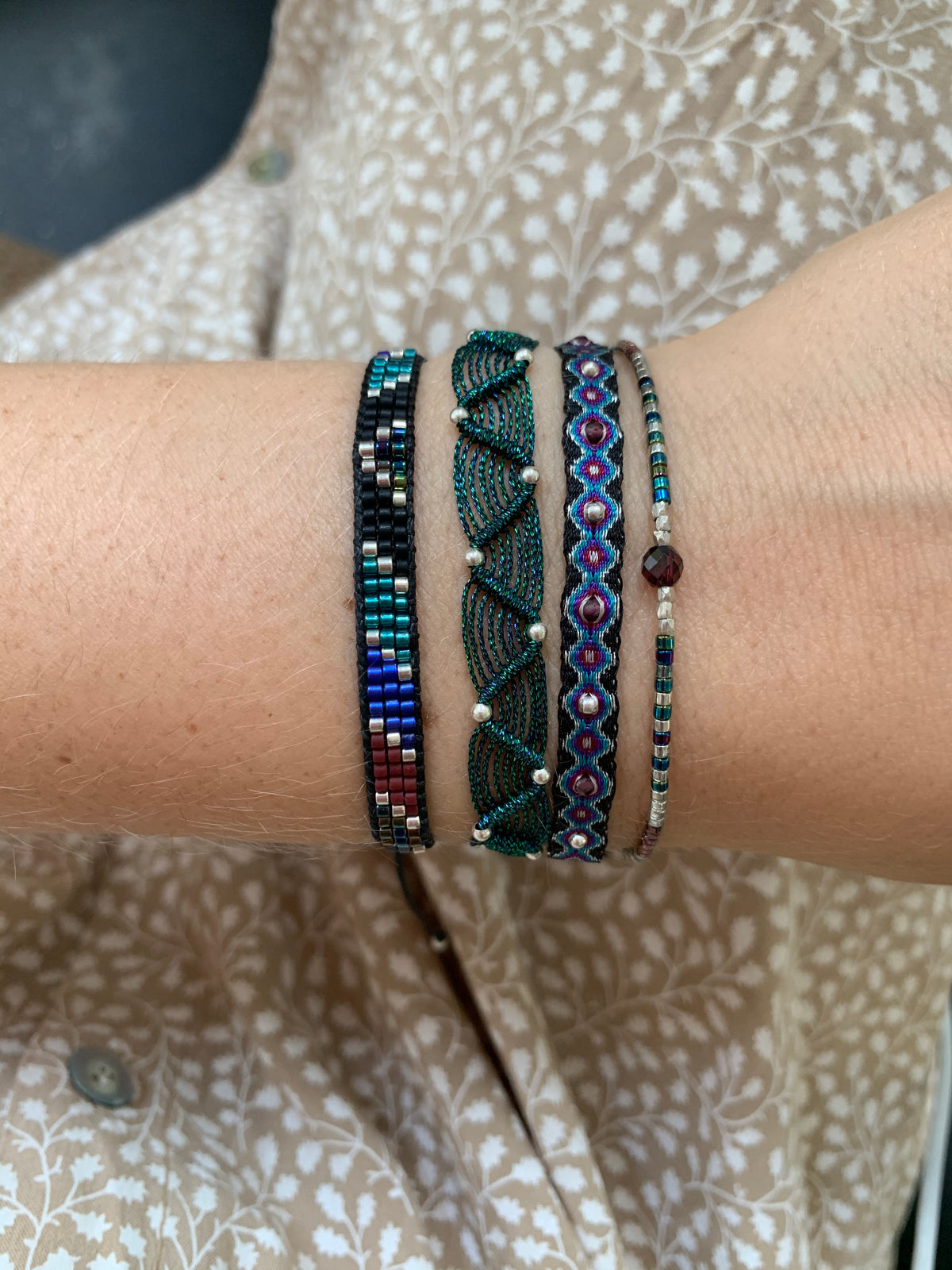 SET OF THREE HANDWOVEN BRACELETS IN DARK TONES WITH SILVER DETAILS