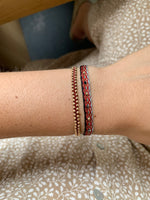 HANDWOVEN BRACELET WITH INTERMIXED STONES IN RED AND BLACK