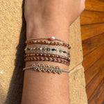GOLDEN HANDWOVEN BRACELET FEATURING GEMSTONES AND GOLD DETAILS
