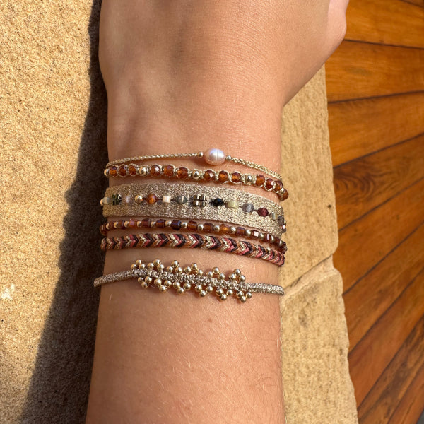 GOLDEN HANDWOVEN BRACELET FEATURING GEMSTONES AND GOLD DETAILS