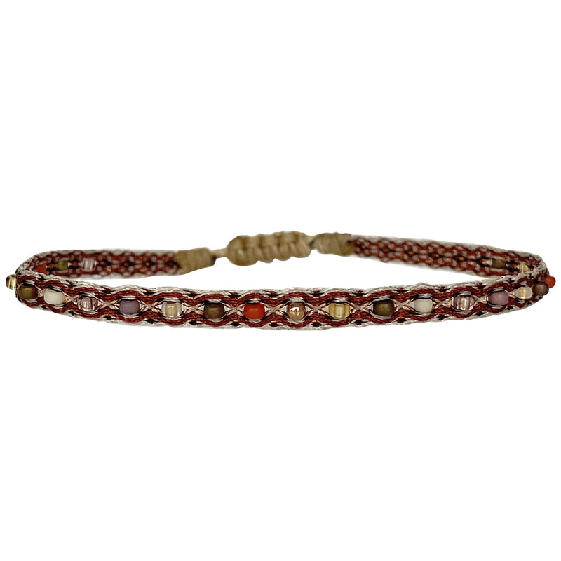 This LeJu bracelet has been handwoven in Colombia by our team of artisans using Polyester threads in neutral tones with a mix of 14 k rose gold filled beads and colourful glass beads.   This can be worn solo or with your favourite pieces.  Details:      Polyester threads     14 k gold filled beads and Glass bead details     Handwoven adjustable bracelet     Width 4mm     Can be worn on the water