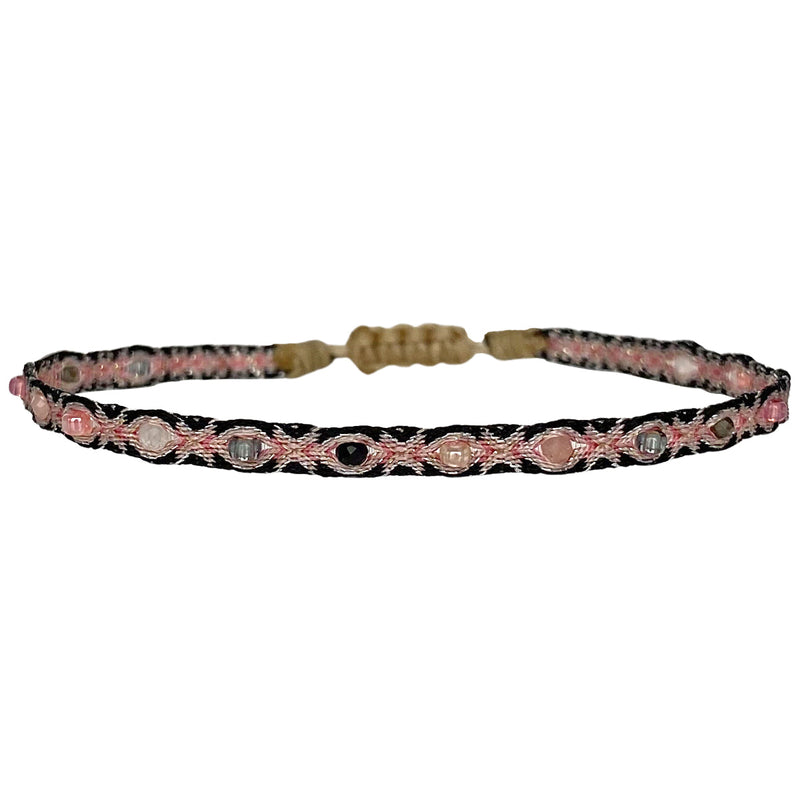 This LeJu bracelet has been handwoven in Colombia by our team of artisans using Polyester threads in pink and black tones with a mix of gemstones and colourful glass beads.   This can be worn solo or with your favourite pieces.  Details:      Polyester threads     Gemstones and Glass bead details     Handwoven adjustable bracelet     Width 4mm     Can be worn on the water