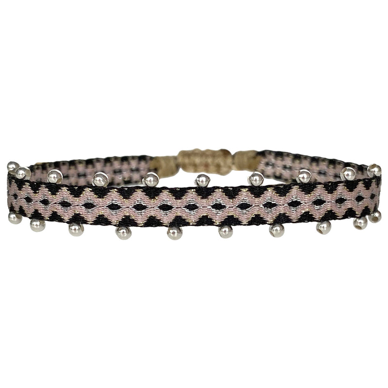 This beautiful hadmade bracelet has been handwoven in Colombia by our team of artisans using Polyester threads in pink tones with silver beads.  This can be worn solo or with your favourite pieces.  Details:      Polyester threads     925 silver beads     Handwoven adjustable bracelet     Width 5mm     Can be worn in the water     Women bracelet