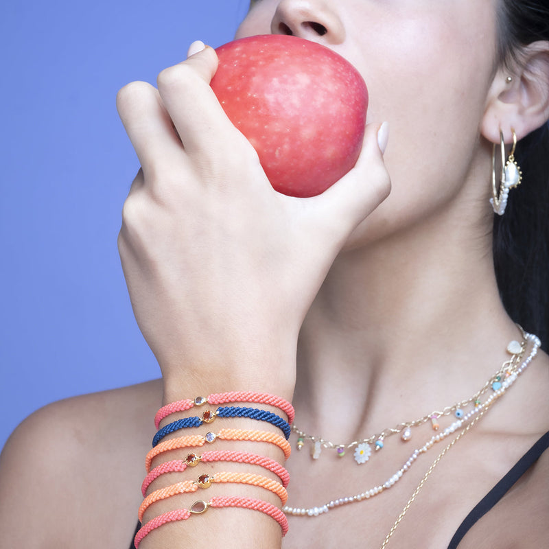 This gorgeus bracelet is handwoven by our team of master artisans using macramé techniques. An impressive Hessonite is the centerpiece of this iconic design. It's the perfect accessory to add a little sparkle in your life.  Details:      Hessonite semi-precious stone     Vermeil setting     Macramé weaving technique     Adjustable handwoven bracelet     Width 4mm