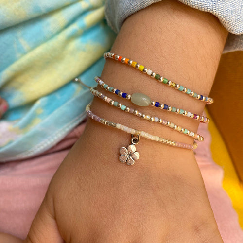 This cool  handwoven bracelet will enchant you with its unique design.This kids bracelet is handwoven using colourful beads and silver beads and a Jade stone as a center piece. Mix it as you like it and wear it with your favourite bracelets!  Details:  -Kids bracelet  -925 sterling silver beads   -Jade semi-precious stone  -colourful beads  -Adjustable bracelet  -Width: 2mm  -Can be worn in the  water